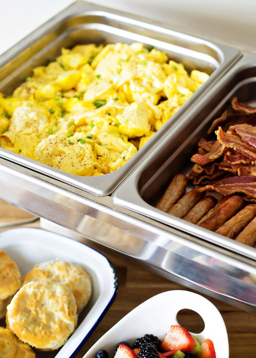 Breakfast buffet with scrambled eggs, sausage and bacon