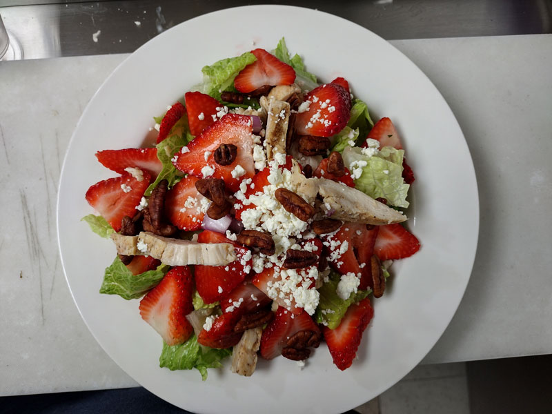 Try Holiday Gardens summer salad; Chicken & Strawberry with candied pecans, romaine lettuce, fajita chicken, red onions, Strawberries, feta cheese and candied pecans. Served with raspberry vinaigrette or their choice of dressing.